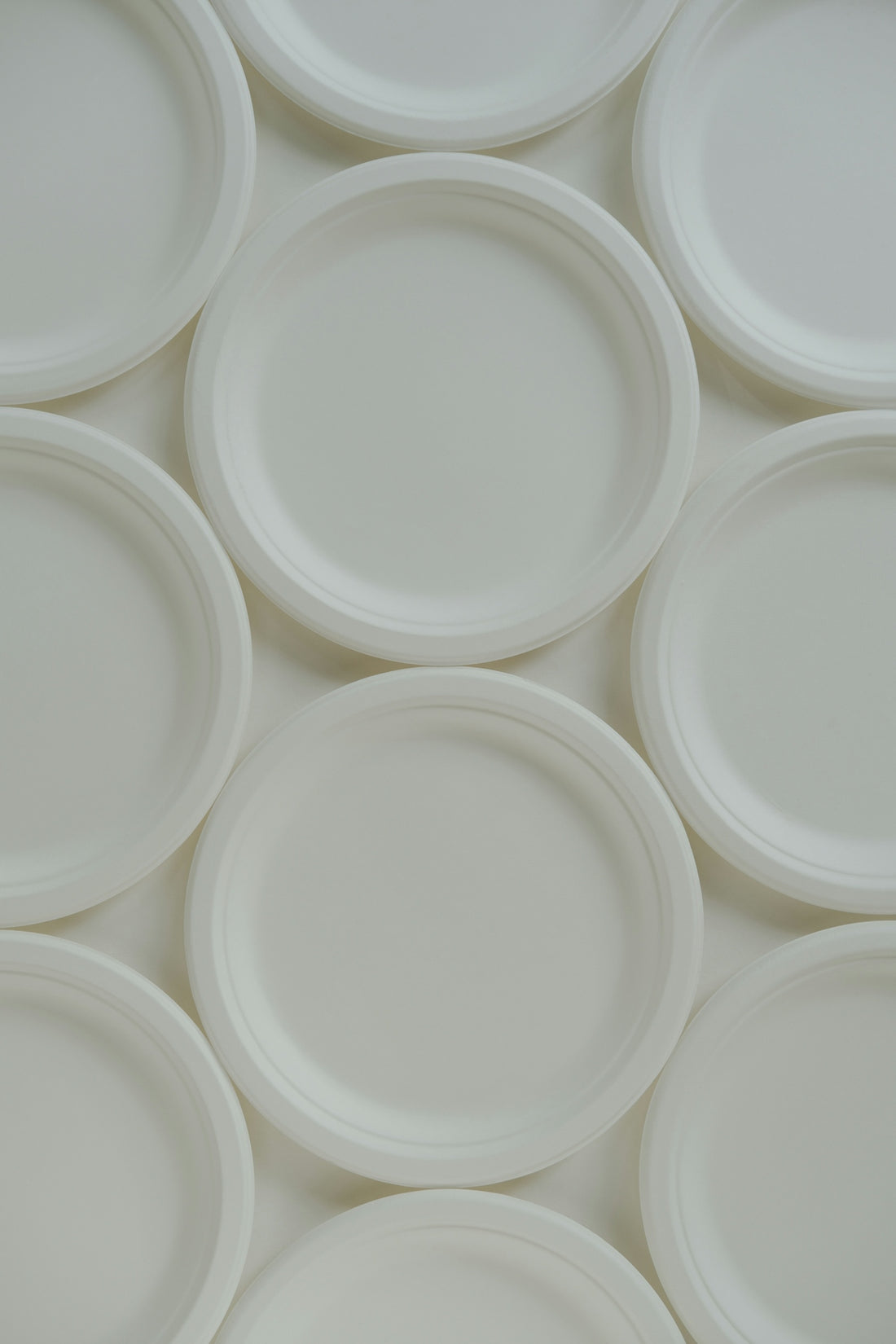 A group of white plates sitting on top of each other