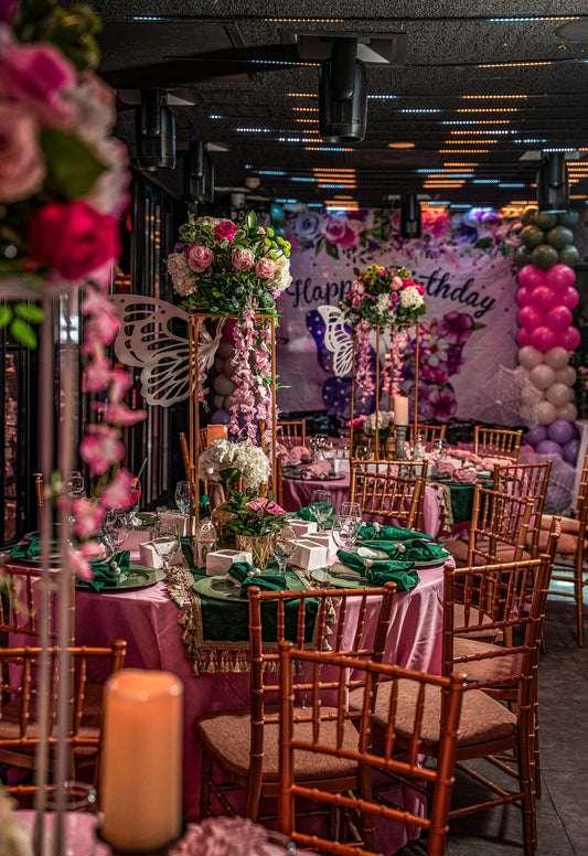 Elegant birthday party setup with floral decorations and balloons