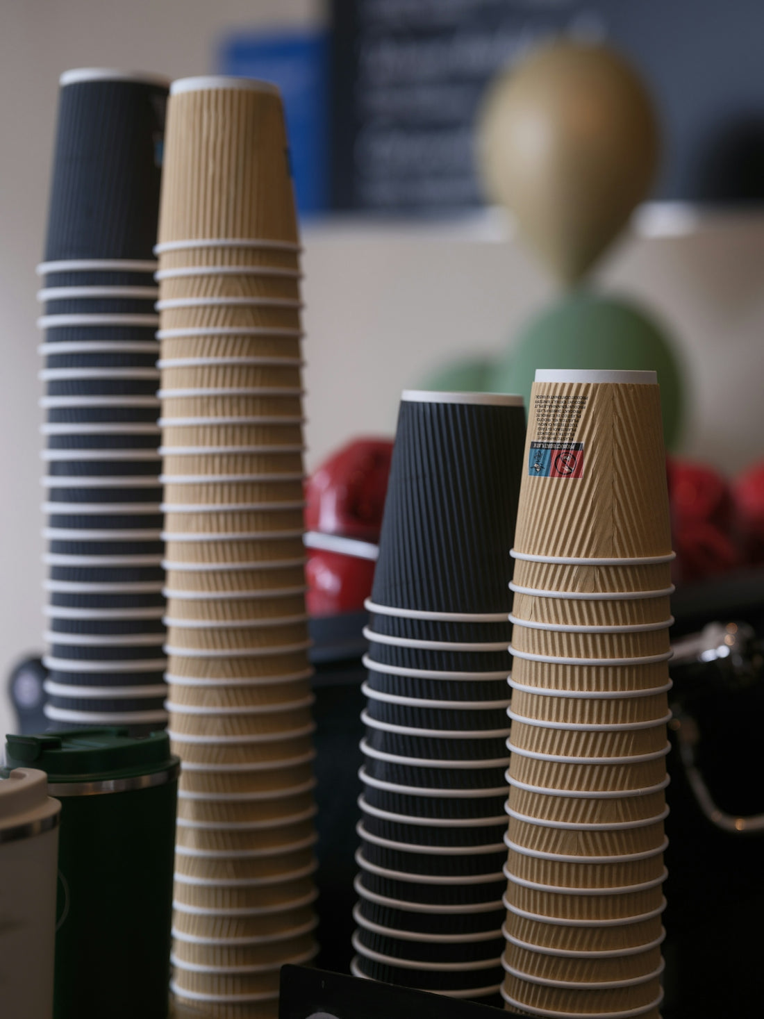 Stacks of disposable coffee cups in various colors