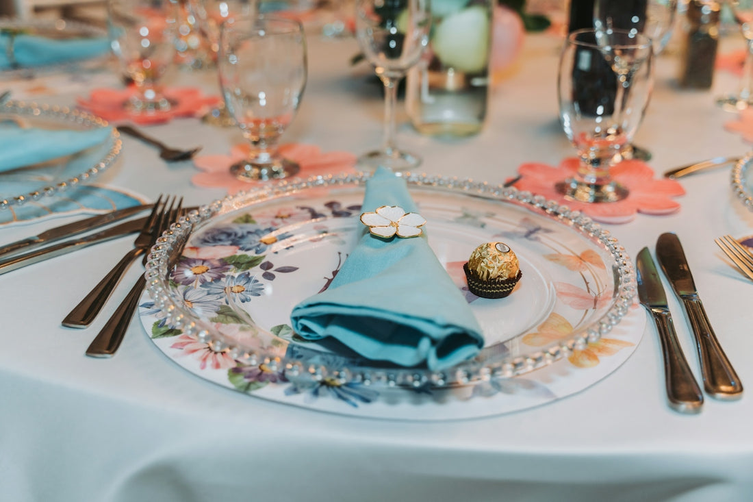 Elegant table setting with floral plates and blue napkins