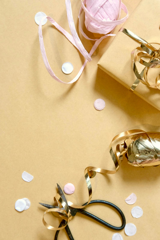 Gift wrapping supplies with scissors and confetti
