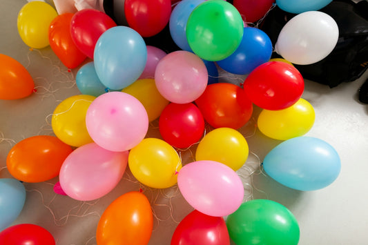 Colorful balloons scattered on a surface